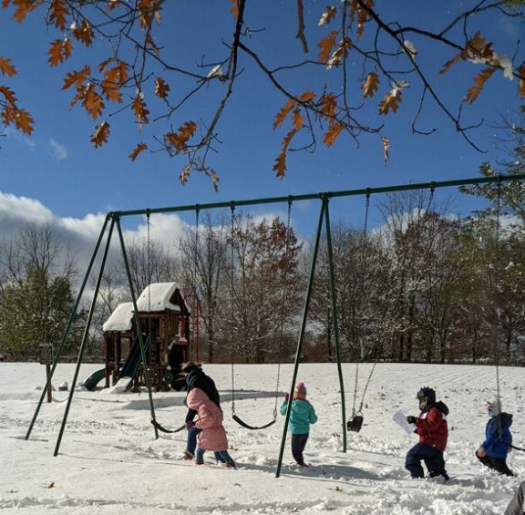 Students in grades 1-3 use compasses to navigate the course.