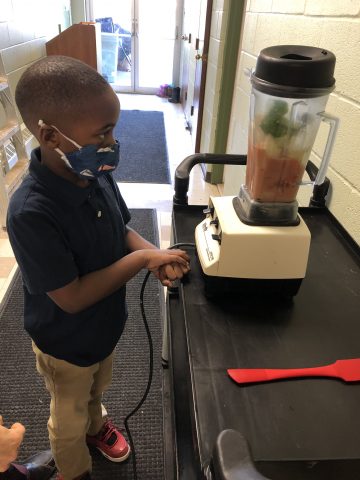 Joshua helps make a produce slurry for the worms to munch on.