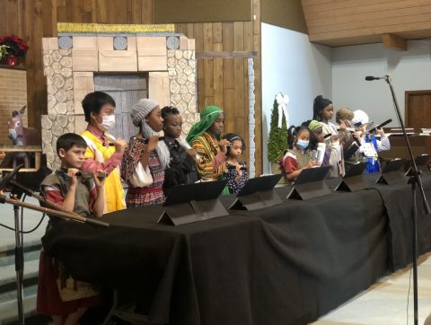 Grades 4-6 play chimes during the Christmas program.