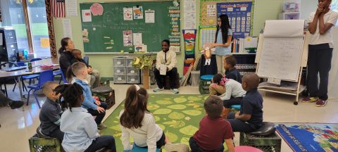 Younger students listen to stories written and read by our upper graders.